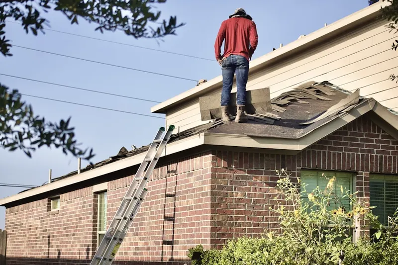 Professional roofer working on a residential roof in Puritan